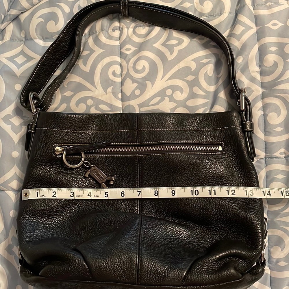 Coach brand Women’s Substantial leather handbag with adjustable strap.